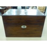 A late Victorian rosewood vanity box, enclosing a part fitted interior with glass containers  7"h