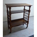 An Arts & Crafts Leonard Wyburd Liberty oak reading table with an angel top, over two shelves, on