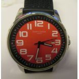 A Simon Carter stainless steel cased wristwatch with sweeping seconds, faced by a red Arabic dial,