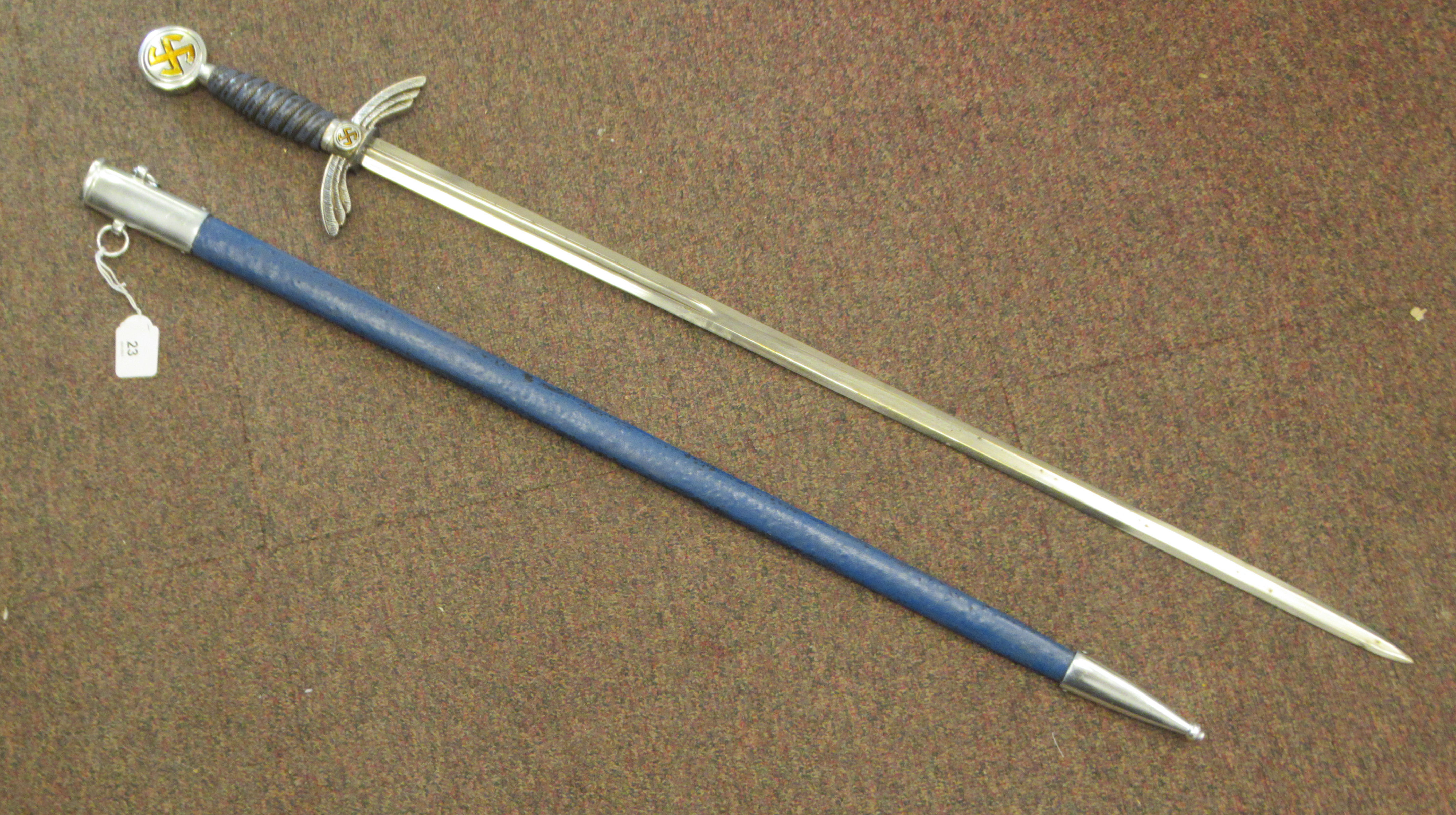 A German Luftwaffe dress sword with swastika emblems on the pommel and hilt, a woven wire bound