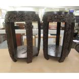 A pair of 20thC Japanese barrel design garden seats, profusely carved and densely decorated with