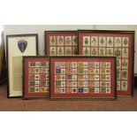 Three framed cigarette 'silks', featuring British regimental insignia; and two framed cigarette