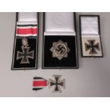 A German Iron Cross 1939 badge  cased; a Knights Cross with a ribbon and oak leaves/crossed