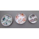 Three dissimilar 19thC Chinese porcelain saucer dishes, variously decorated with floral designs