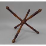 A late 19thC fruitwood wool winder, comprising six ring turned spindles, threaded to the central