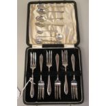 A set of six silver cake forks  SL Birmingham 1934  cased; and seven various silver condiments and