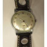 A 1960s Cyma stainless steel cased wristwatch, faced by a silvered Arabic dial, incorporating a