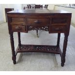 An early 20thC Chinese rosewood kneehole dressing table with a concealed mirror and three drawers,