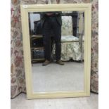 A modern bevelled mirror, set in a cream coloured, speckled frame  39" x 28"