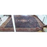 A Persian carpet, decorated with a central medallion, bordered by birds amongst foliage, on a