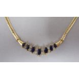 A 14ct flexible snake link necklet, set with alternating sapphires and diamonds