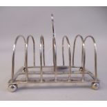 A silver six division wire toastrack, on a rectangular platform and ball feet  Sheffield 1914