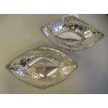 A pair of Edwardian silver bead bordered and uniformly pierced navette shape sweet dishes