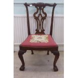 A George III and later Chippendale design, carved mahogany splat back dining chair, the drop-in