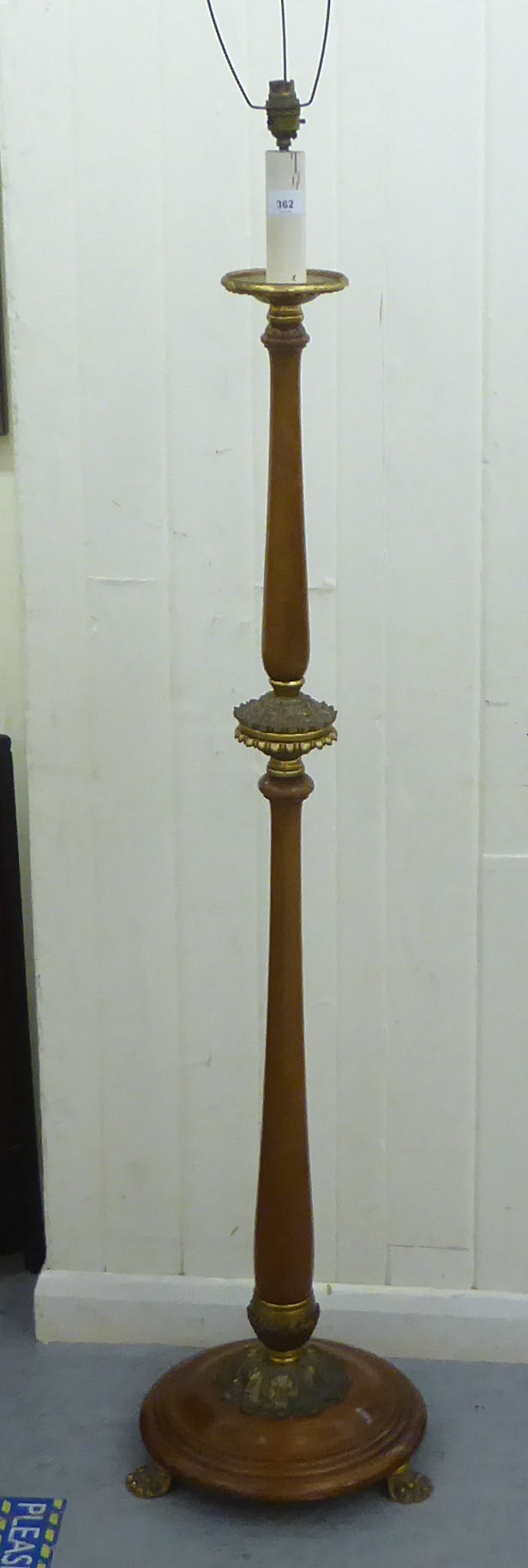 A 1930s turned mahogany and cast brass mounted candle style standard lamp, on a domed base and