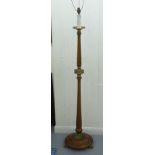 A 1930s turned mahogany and cast brass mounted candle style standard lamp, on a domed base and