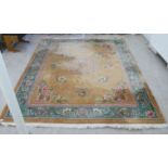 A 20thC Chinese washed woollen carpet, traditionally decorated with flora in pastel tones, on a