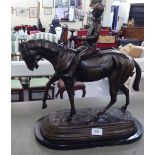 In the manner of Isidore Bonheur - a cast and painted bronze figure, a mounted jockey, on a black
