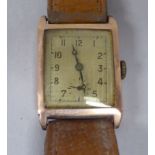A mid 20thC 9ct gold cased wristwatch, faced by an Arabic dial, on a brown hide strap