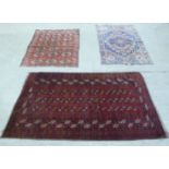 Three rugs: to include a Turkoman, on a red ground  38" x 52"