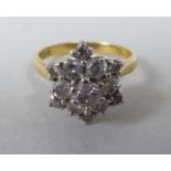 An 18ct gold claw set diamond cluster ring