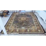 A Persian carpet, decorated with a central medallion, bordered by small repeating floral designs, on