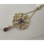 A Victorian 15ct gold seed pearl and amethyst set pendant, on a curb link chain with a ring bolt