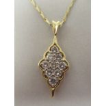 A gold coloured metal nine stone set diamond pendant, on a fine twist wire link neckchain and ring