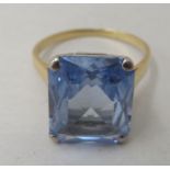 An 18ct gold cocktail ring, set with a blue stone