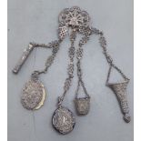 A late 19th/early 20thC decoratively cast white metal chatelaine, comprising a belt hook and four