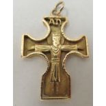 A yellow metal pendant crucifix