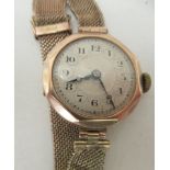 A ladies 9ct gold cased wristwatch, on a wide flexible bracelet, faced by an Arabic dial