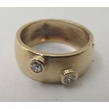 A 9ct gold band, set with two diamonds