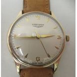 A 9ct gold cased Longines manual wristwatch, faced by an Arabic dial, on a tan leather strap