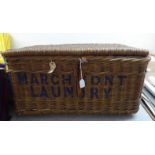 An early 20thC woven cane basket, inscribed Marchmont Laundry  15" x 30" x 21"