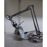A modern stainless steel Anglepoise type table lamp