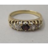An 18ct gold ring, set with diamonds and a red stone