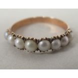 A 9ct rolled gold ring, set with eight pearls