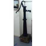 A Terpo black painted cast iron water pump head, secured to a concrete plinth  65"h