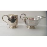 A silver Christening mug with an applied wire rim and C-scroll handle, on a pedestal footrim; and