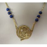 An 18ct gold Scandinavian lapis lazuli and diamond set pendant, on a rod and ring link neckchain