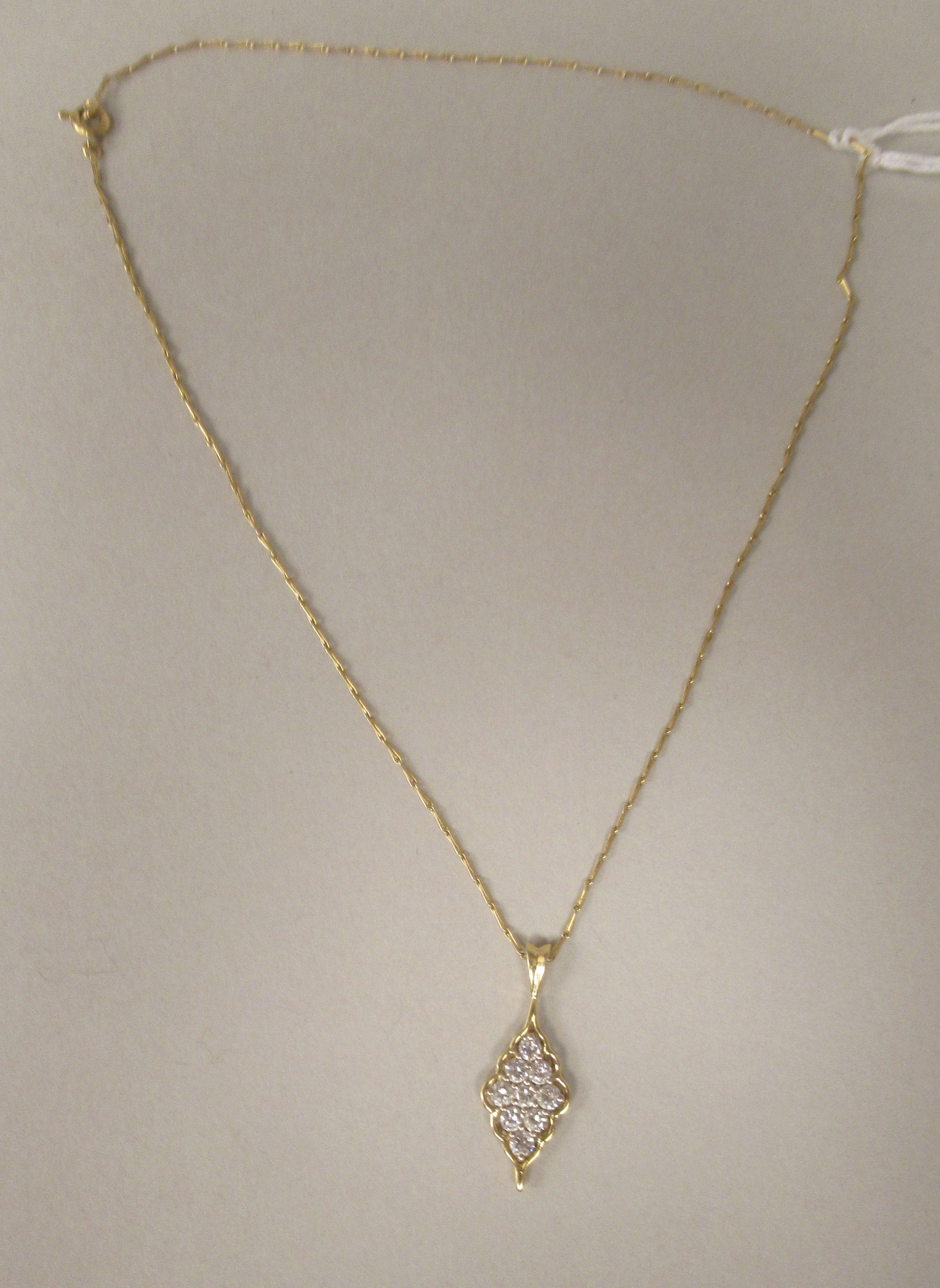 A gold coloured metal nine stone set diamond pendant, on a fine twist wire link neckchain and ring - Image 2 of 3