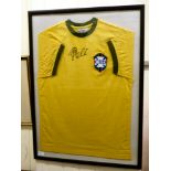 A framed Brazilian football shirt  bears a pen signature  size medium  22" x  31"