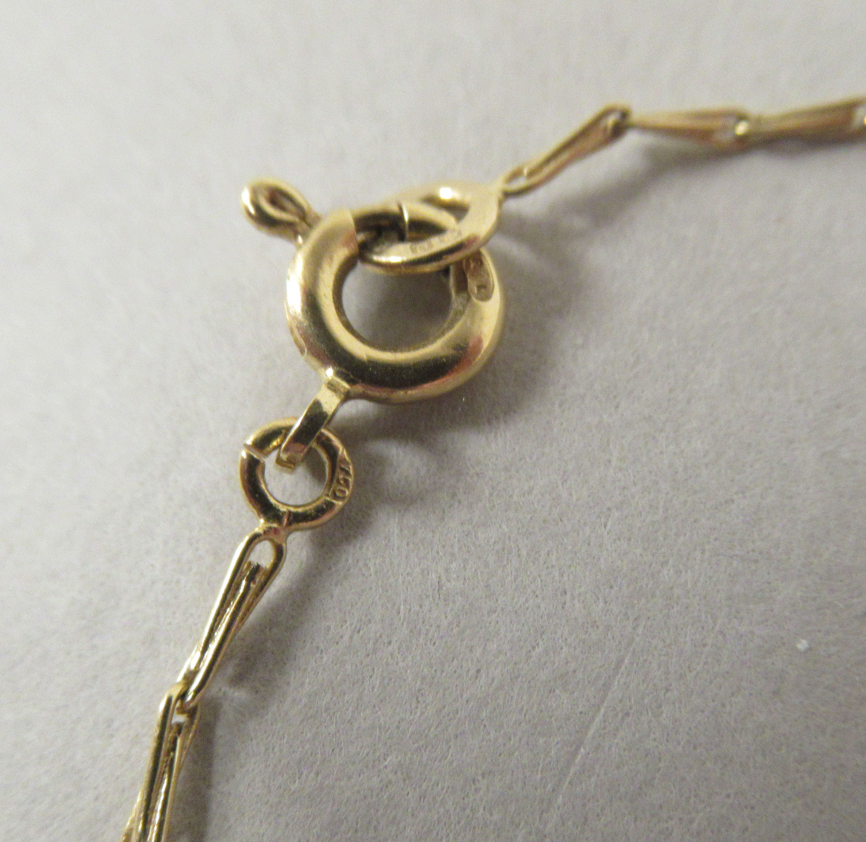 A gold coloured metal nine stone set diamond pendant, on a fine twist wire link neckchain and ring - Image 3 of 3