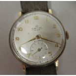 A 1950s Smiths DeLuxe 9ct gold cased wristwatch, faced by a gilded Arabic dial, incorporating