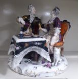 A Continental porcelain group, a man and woman in conversation, seated at a table  9"h