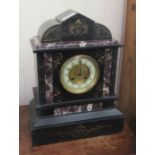 An early 20thC slate and marble cased mantel clock of architectural form, on a plinth; the