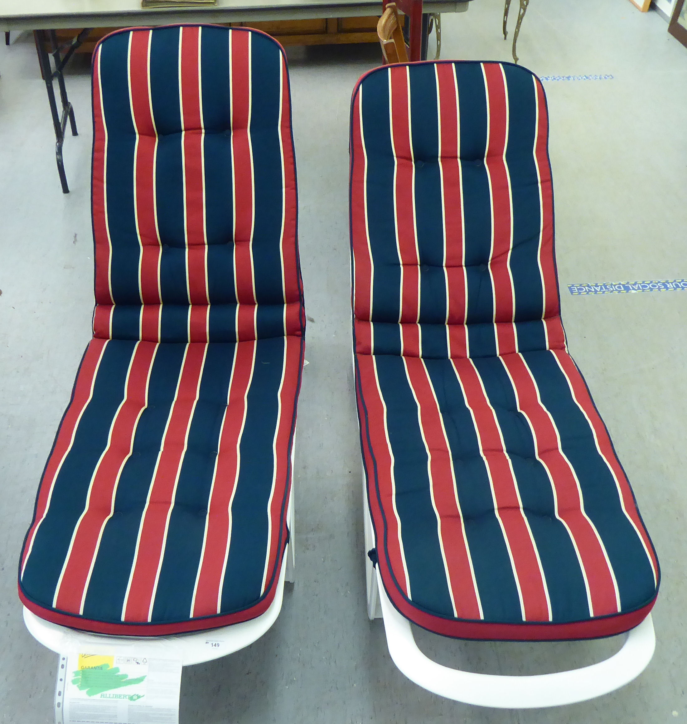 A pair of Allibert Cormoran wheeled white plastic sun-loungers with De Luxe Blazer cushions