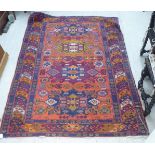 A Persian rug, decorated with repeating design, in bright colours  60" x 76"