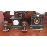 Two similar late Victorian black slate cased mantel clocks; each with an 8 day movement, faced by